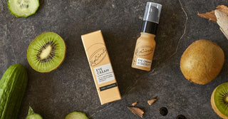 A boxed and unboxed eye cream surrounded by kiwis slices and cucumbers